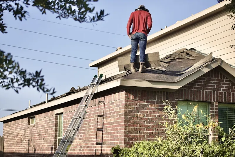 Professional roofer working on a residential roof in Elm Grove